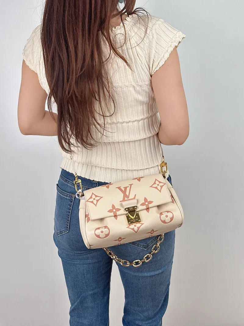 Louis Vuitton Crossbody Bag Favorite White · Pink Empreinte Embossed Calfskin Monogram Medium24 × 9 × 14 cm — on-model view 3 of 3