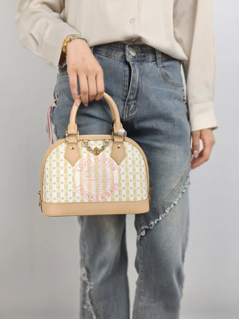 Louis Vuitton Top Handle Bag Alma BB Yellow White Canvas BB 23.5 × 11.5 × 17.5 cm — on-model view 2 of 2