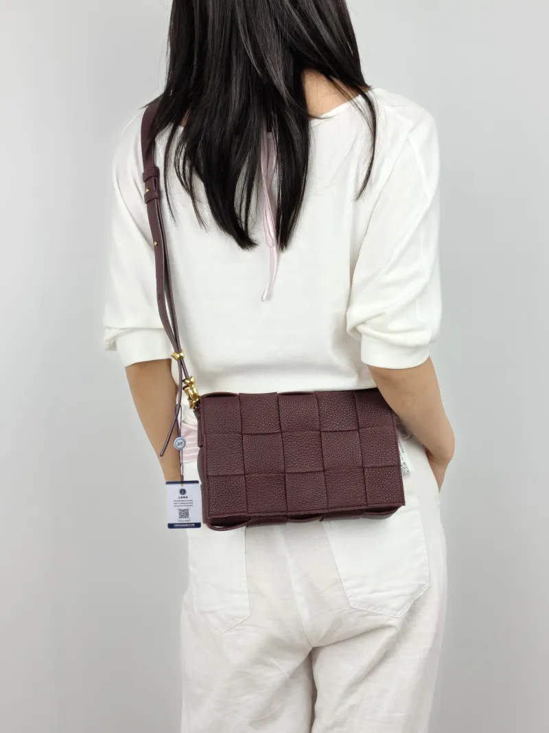 Bottega Veneta Crossbody Bag Cassette Woven Burgundy Calfskin Medium 23 × 5 × 15 cm — on-model view 1 of 2