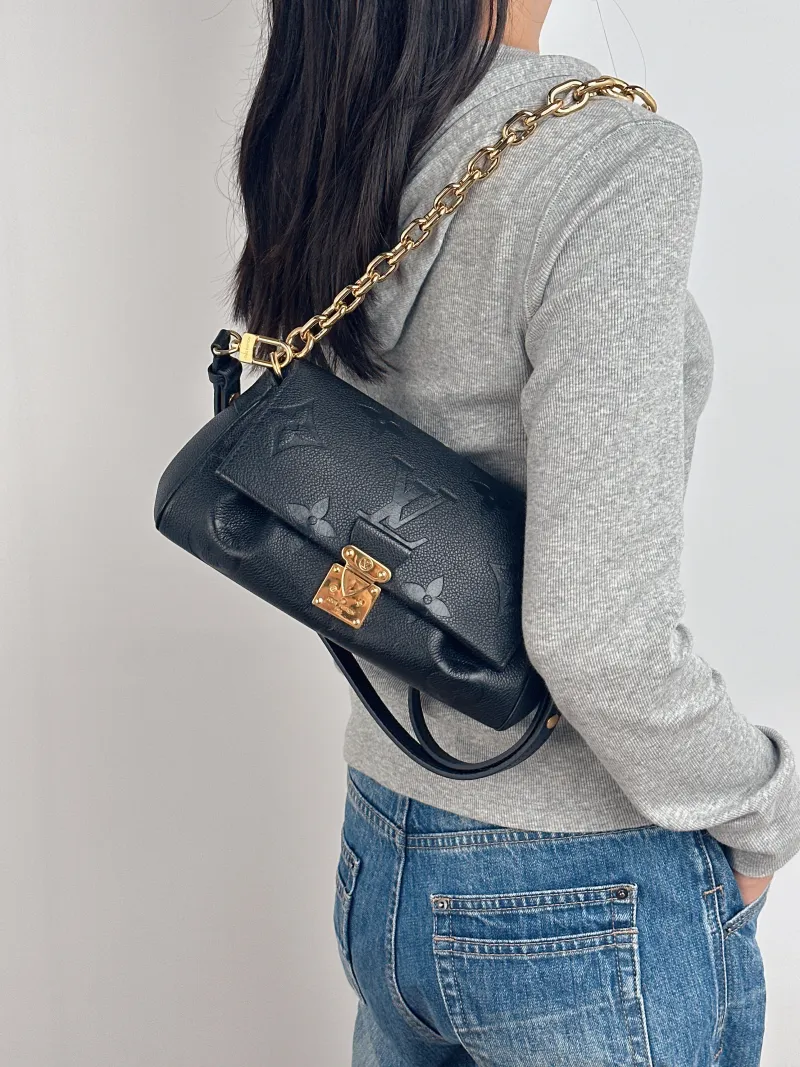 Louis Vuitton Crossbody Bag Favorite Black Monogram Empreinte Embossed Calfskin Medium 24 × 9 × 14 cm — on-model view 1 of 3