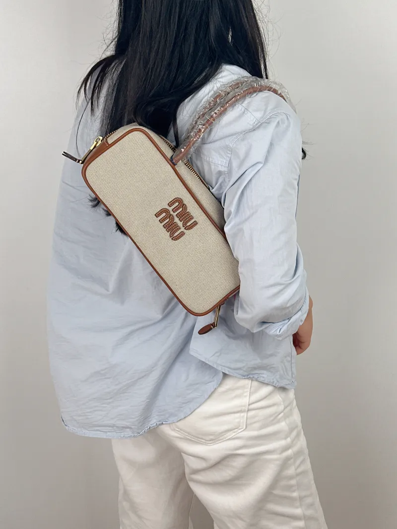 Miumiu Top Handle Bag Beau Brown Canvas · Calfskin Small 28 × 8 × 11.5 cm — on-model view 2 of 2