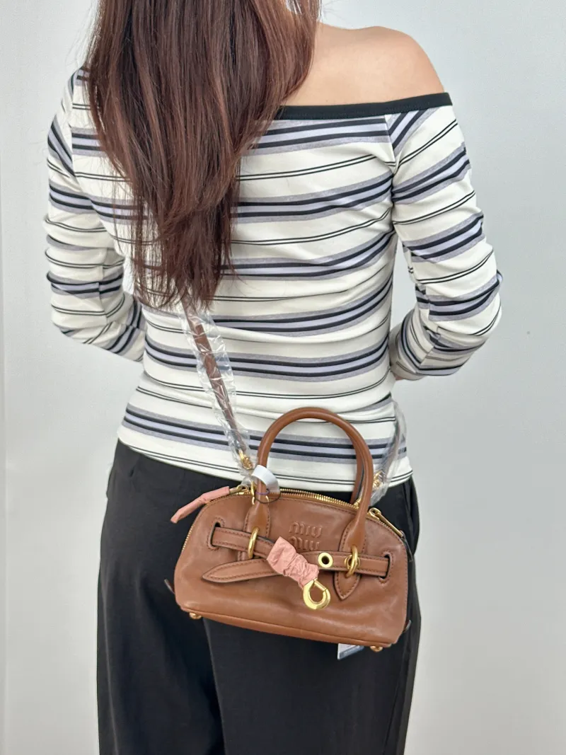 Miumiu Top Handle Bag Aventure Top Handle Bag SL ambskin Mini 21 × 8 × 13.2 cm — on-model view 1 of 2
