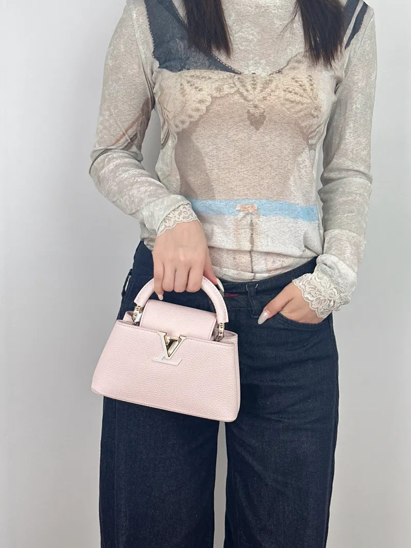 Louis Vuitton Top Handle Bag Capucines East West Pink Calfskinmini22 × 8 × 12 cm — on-model view 2 of 3