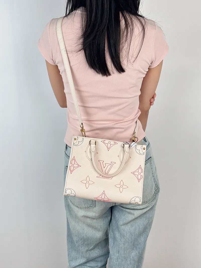 Louis Vuitton Top Handle Bag Onthego White · Embroidered Calfskin Small25 × 11.5 × 19 cm — on-model view 1 of 3