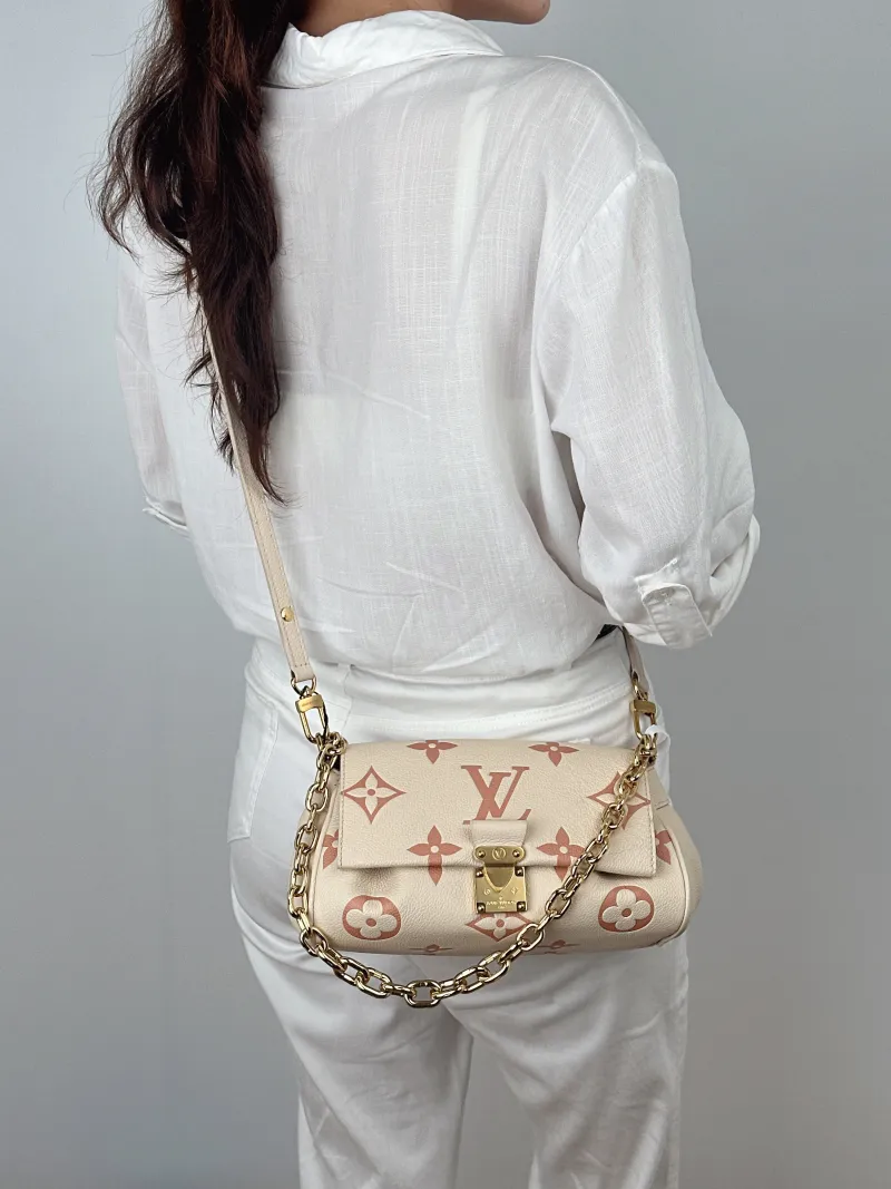 Louis Vuitton Crossbody Bag Favorite White · Pink Empreinte Embossed Calfskin Monogram Medium24 × 9 × 14 cm — on-model view 1 of 2