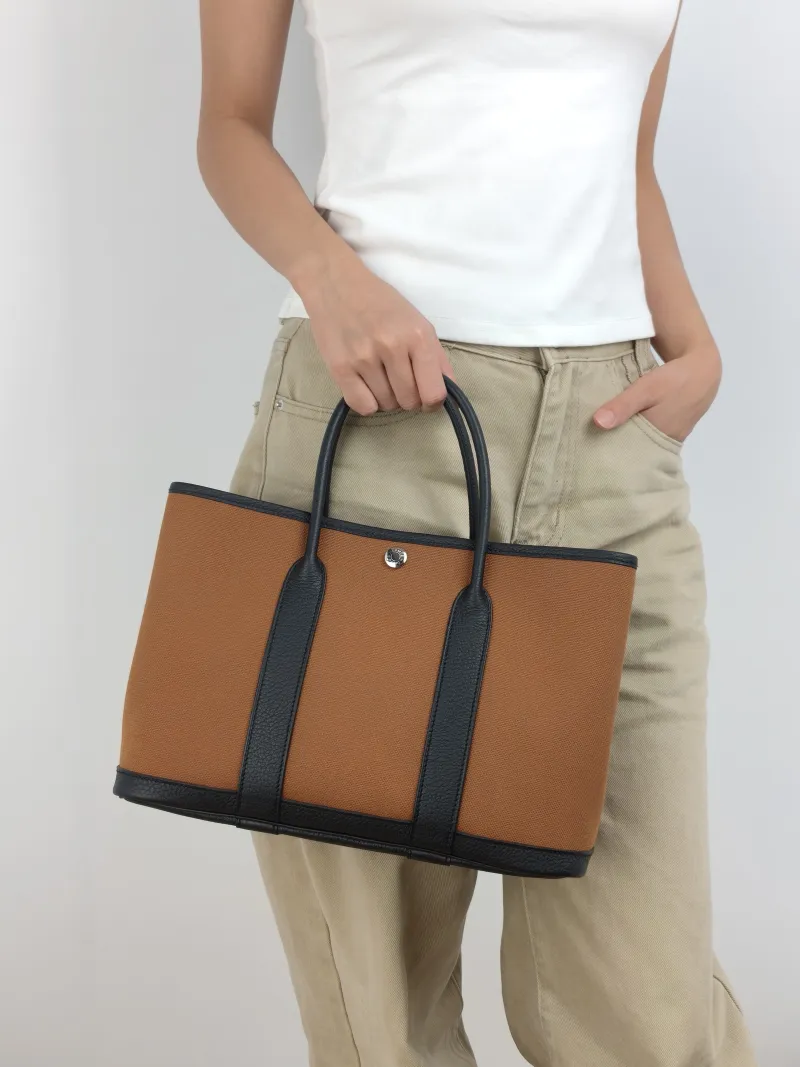 Hermès Top Handle Bag Garden Party 30 30 Brown Canvas · Negonda Calfskin Medium 30 × 13 × 21 cm B — on-model view 1 of 2