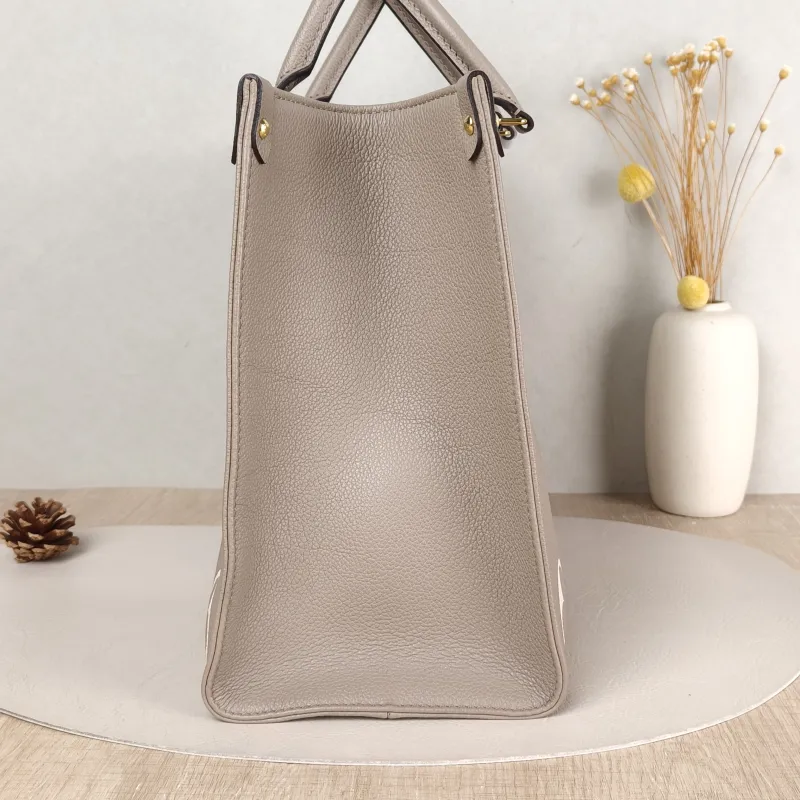 Louis Vuitton Shoulder Bag Onthego Medium · White Monogram Empreinte Embossed Calfskin Medium 35 × 14 × 27 cm — detail view 10 of 11