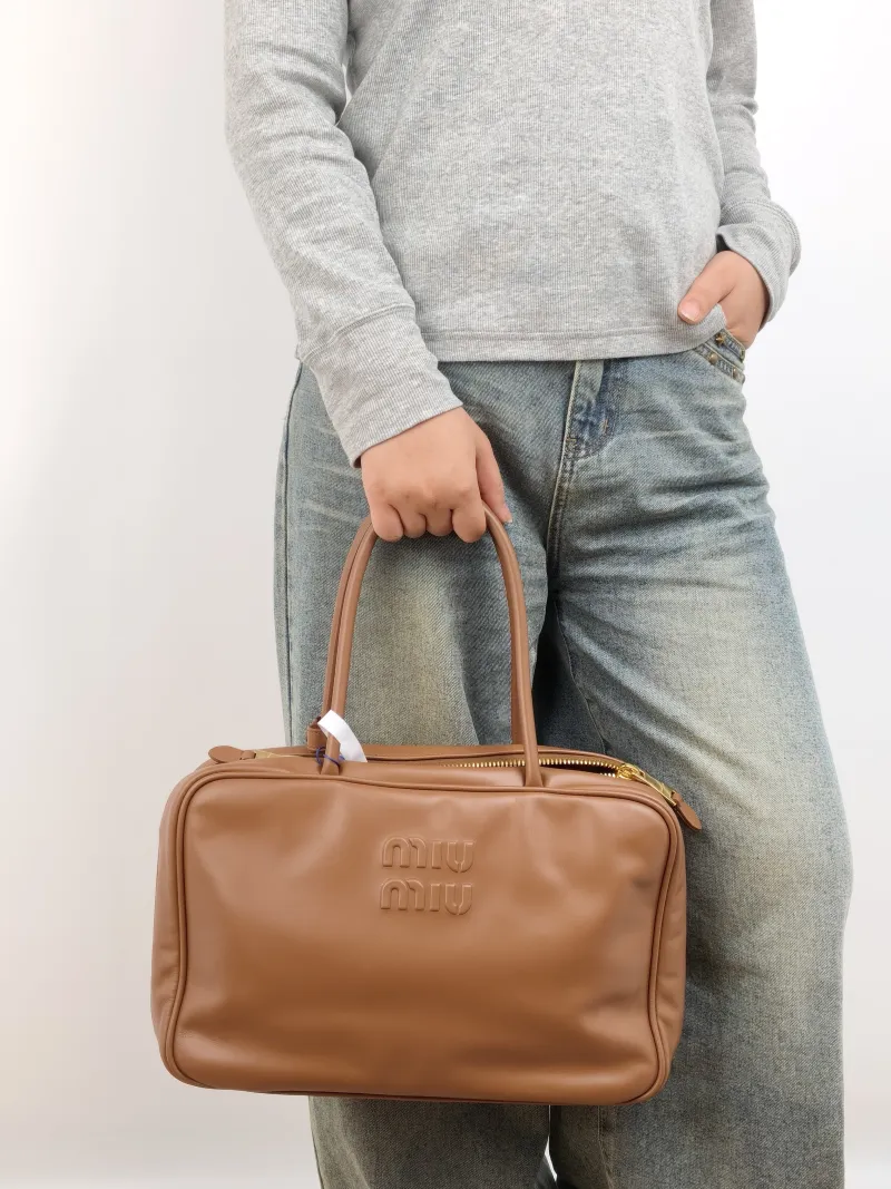 Miumiu Top Handle Bag Beau CC alfskin Large 34 × 10 × 23 cm — on-model view 1 of 2