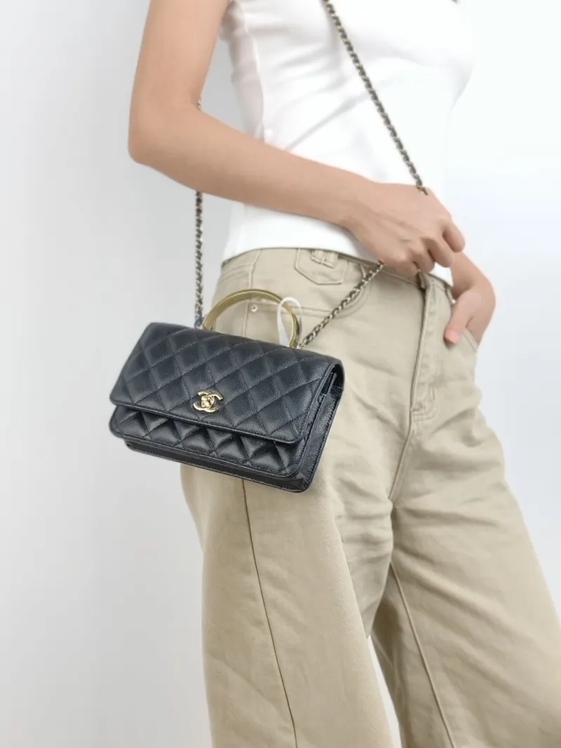 Chanel Crossbody Bag woc Black with Gold-Tone Hardware Grained Calfskin One Size 19.2 × 3.5 × 12.3 cm — on-model view 1 of 3