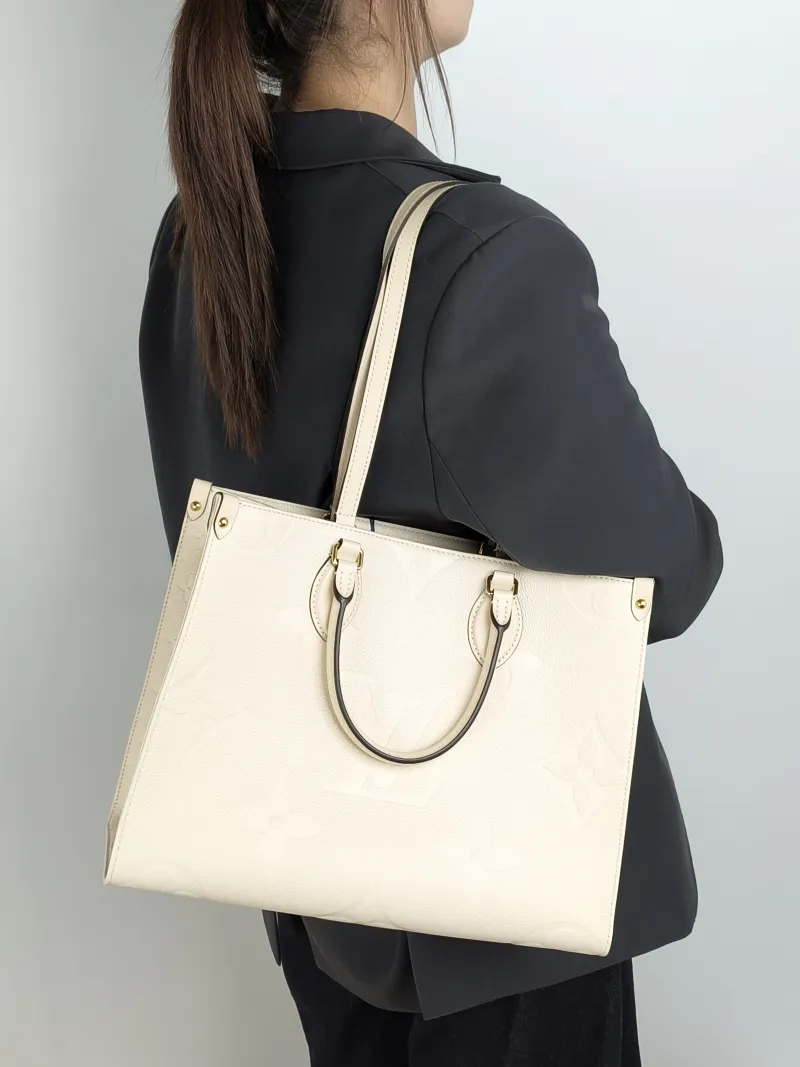 Louis Vuitton Shoulder Bag Onthego Medium White Monogram Empreinte Embossed Calfskin Medium 35 × 14 × 27 cm — on-model view 2 of 3
