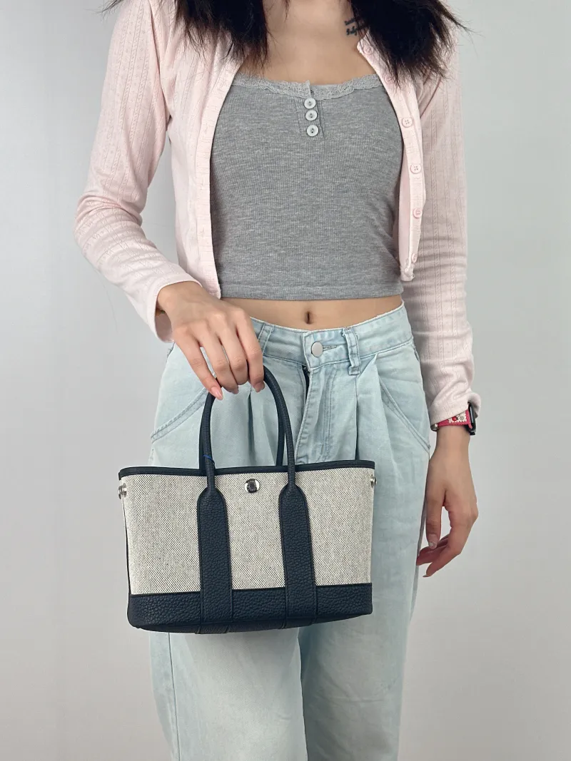 Hermès Top Handle Bag Neo Garden 23 Mini Black · Beige Canvas · Negonda Calfskin Mini 23 × 10 × 16 cm G — on-model view 2 of 2