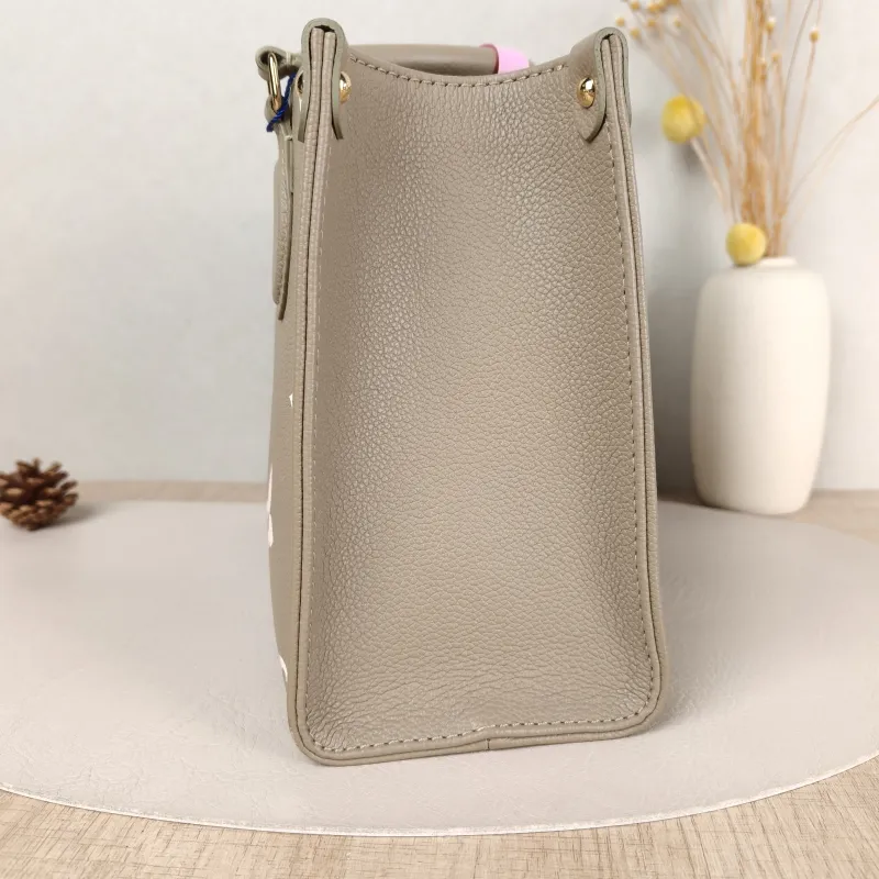Louis Vuitton Top Handle Bag Onthego Monogram Empreinte Embossed Calfskin Small 25 × 11.5 × 19 cm — detail view 8 of 10
