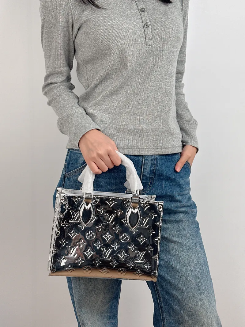 Louis Vuitton Top Handle Bag Onthego Silver Patent Leather Small 25 × 11.5 × 19 cm — on-model view 3 of 3