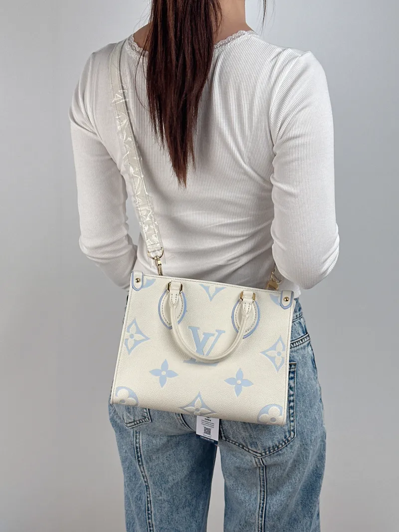 Louis Vuitton Shoulder Bag Onthego White · Blue Monogram Empreinte Embossed Calfskin Small 25 × 11.5 × 19 cm — on-model view 1 of 3