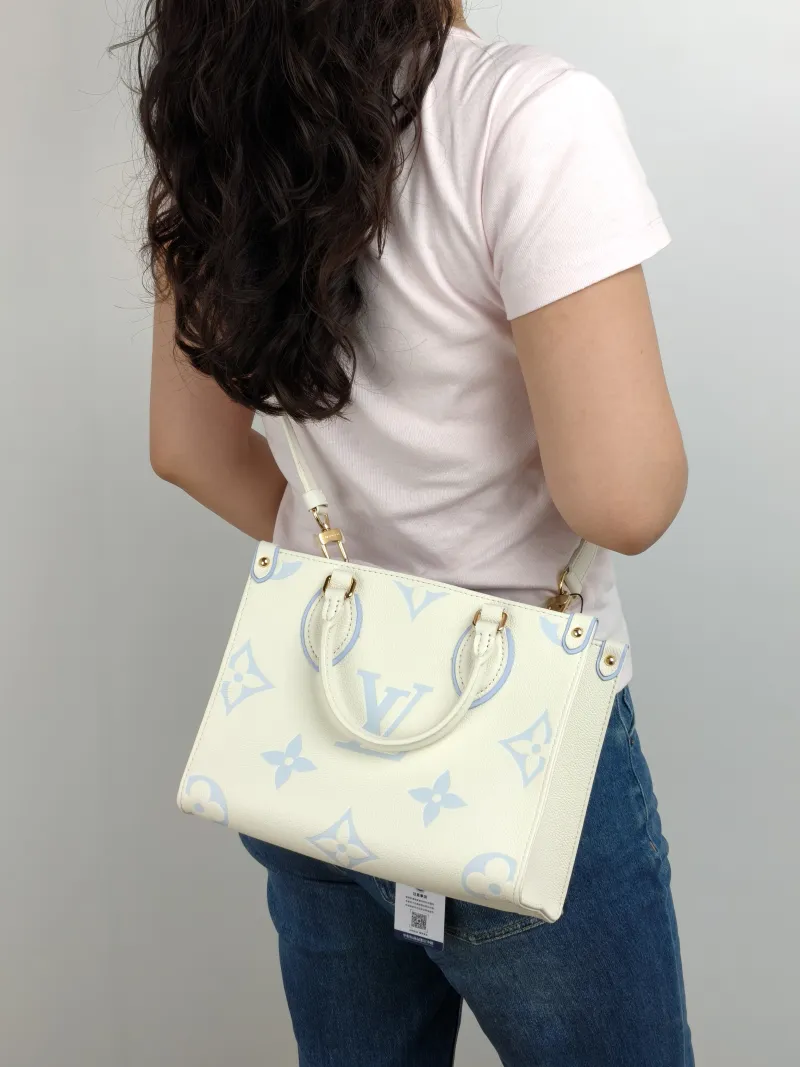 Louis Vuitton Shoulder Bag Onthego White · Blue Monogram Empreinte Embossed Calfskin Small 25 × 11.5 × 19 cm — on-model view 1 of 2