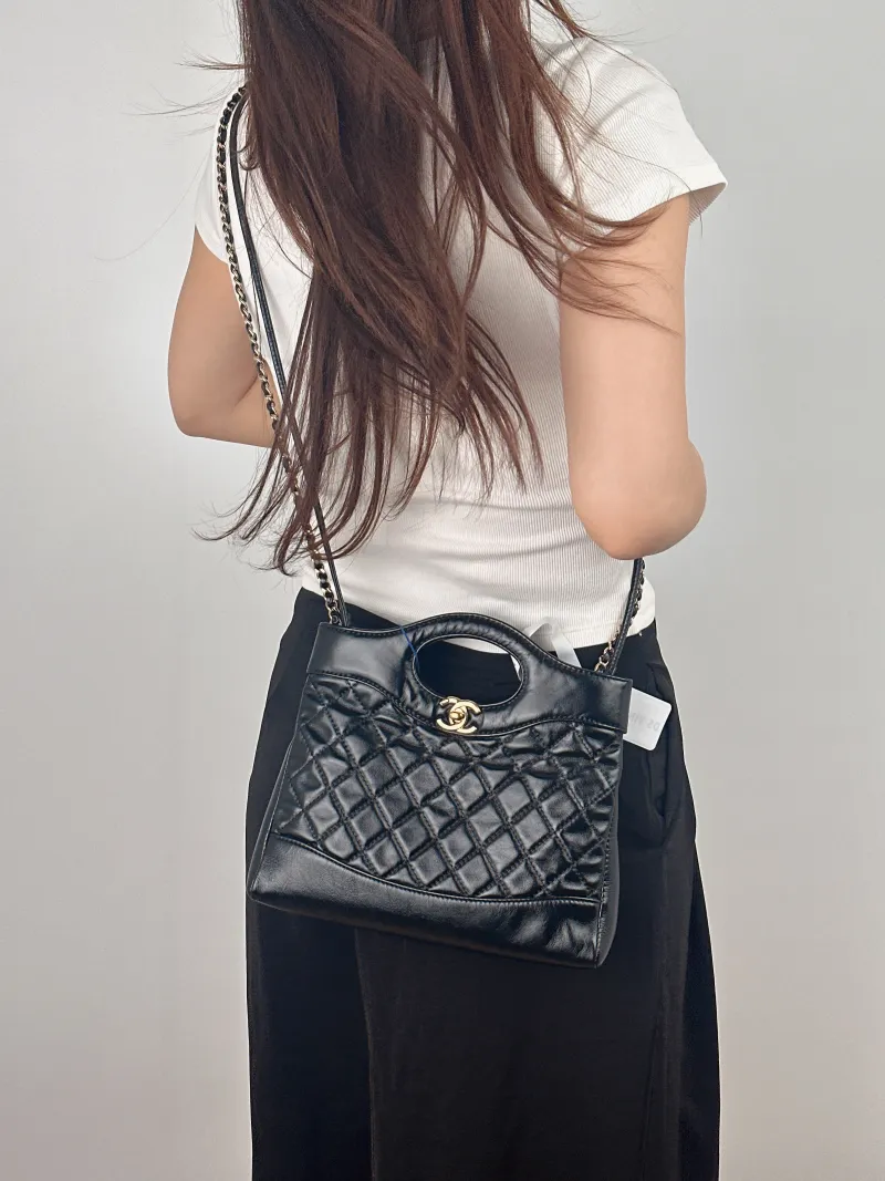 Chanel Crossbody Bag 31Bag Black Waxed Leather Mini 23 × 5.5 × 22 cm — on-model view 1 of 2
