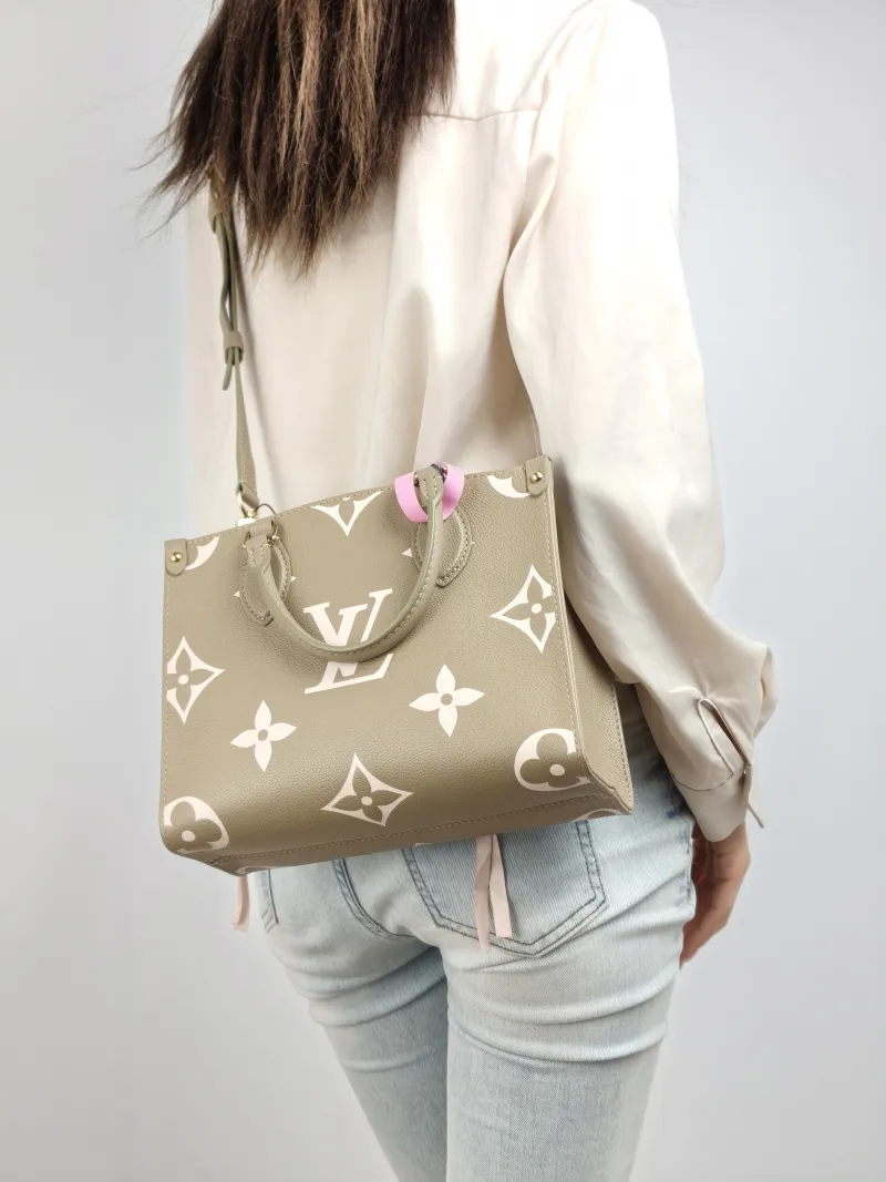 Louis Vuitton Top Handle Bag Onthego Monogram Empreinte Embossed Calfskin Small 25 × 11.5 × 19 cm — on-model view 1 of 2