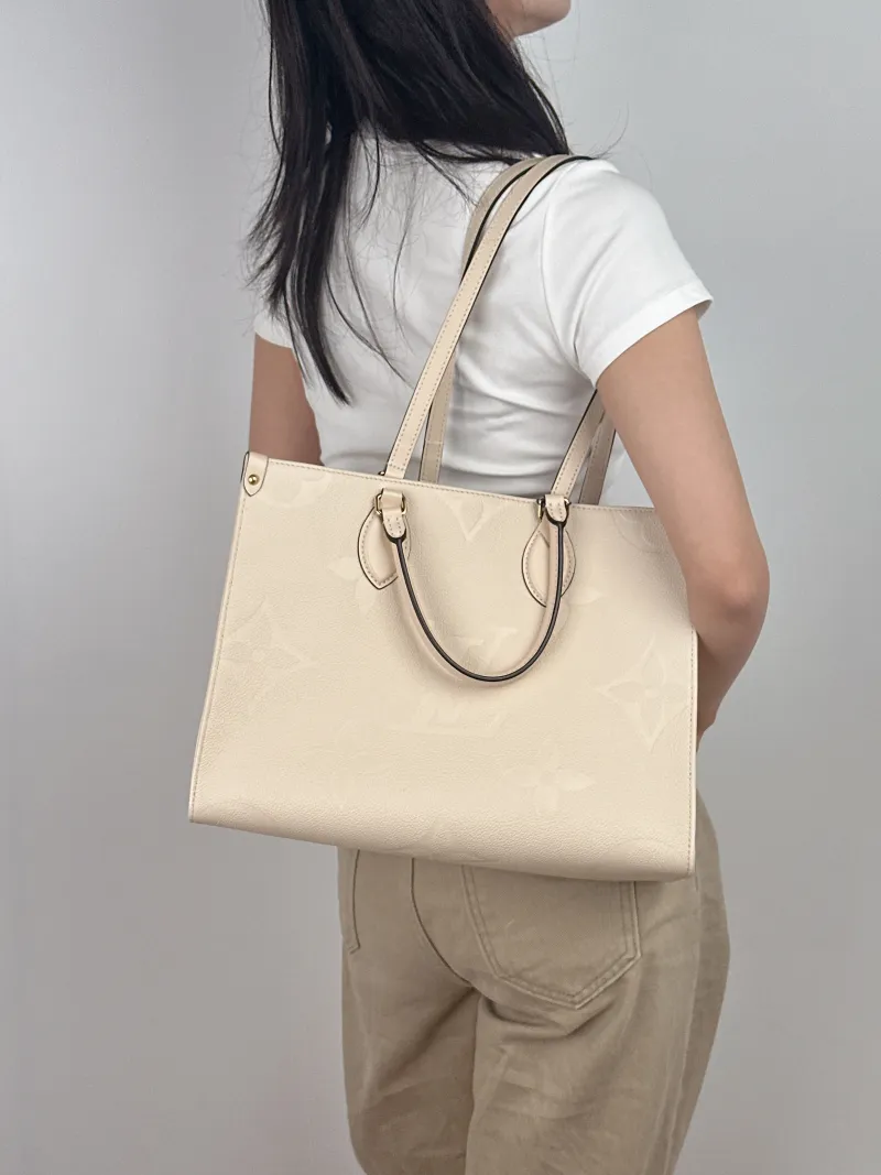 Louis Vuitton Shoulder Bag Onthego Medium White Monogram Empreinte Embossed Calfskin Medium 35 × 14 × 27 cm — on-model view 1 of 2
