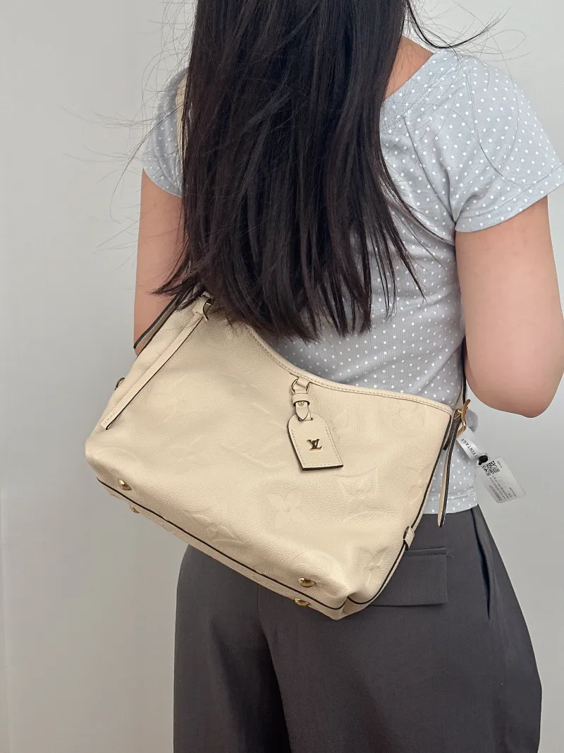 Louis Vuitton Crossbody Bag Carryall White Calfskin Small 29.5 × 12 × 24 cm — on-model view 1 of 2