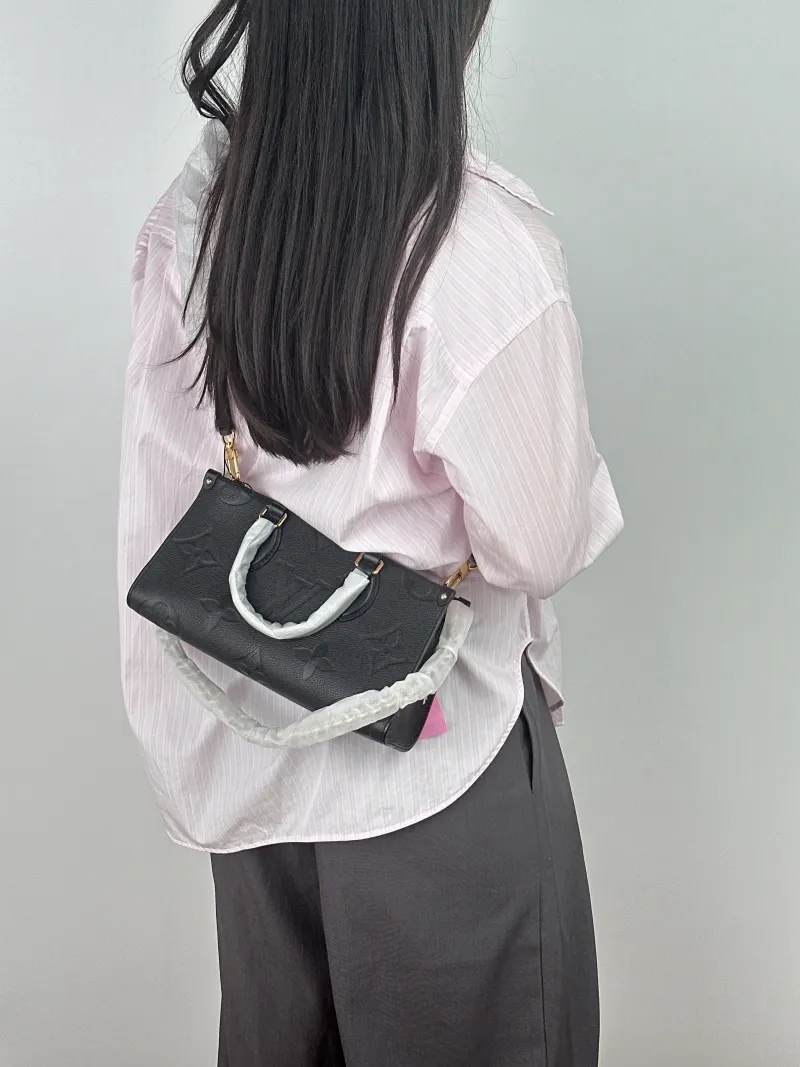 Louis Vuitton Crossbody Bag Onthego East West Two Straps Black Empreinte Embossed Calfskin Small 25 × 10 × 13 cm — on-model view 2 of 2
