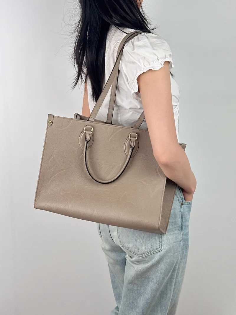 Louis Vuitton Shoulder Bag Onthego Medium Monogram Empreinte Embossed Calfskin Medium 35 × 14 × 27 cm — on-model view 1 of 2