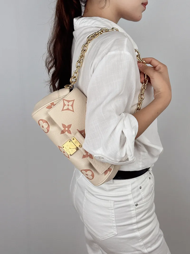 Louis Vuitton Crossbody Bag Favorite White · Pink Empreinte Embossed Calfskin Monogram Medium24 × 9 × 14 cm — on-model view 2 of 2