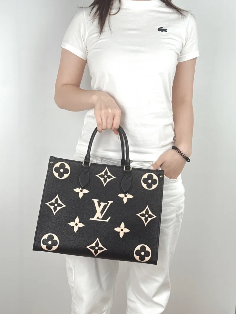Louis Vuitton Shoulder Bag Onthego Medium Black · White Empreinte Embossed Calfskin Monogram Medium35 × 14 × 27 cm — on-model view 1 of 2