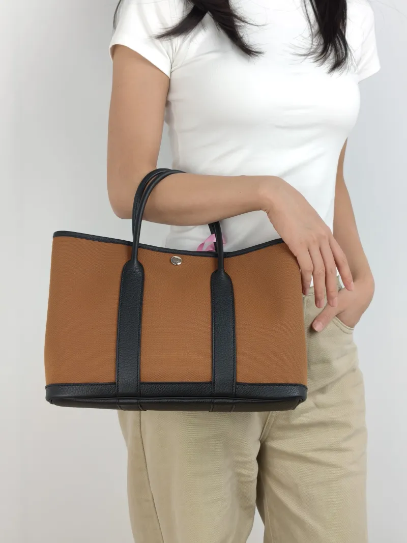Hermès Top Handle Bag Garden Party 30 30 Brown Canvas · Negonda Calfskin Medium 30 × 13 × 21 cm B — on-model view 2 of 2