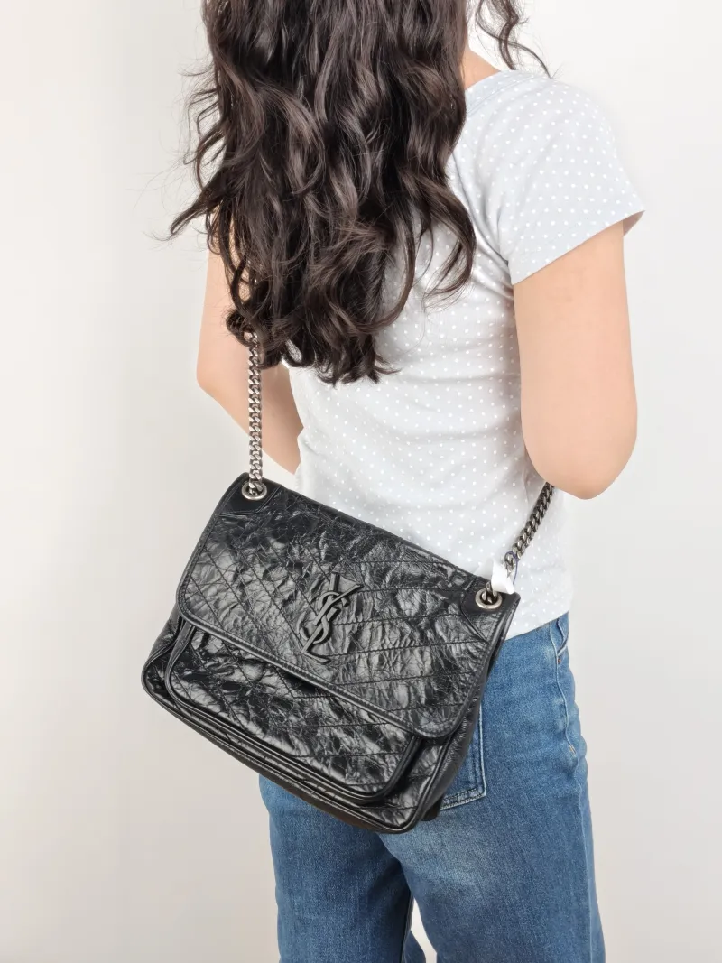 SAINT LAURENT Crossbody Bag Niki D Waxed Leather Calfskin Medium 28 × 8.5 × 20 cm — on-model view 1 of 2