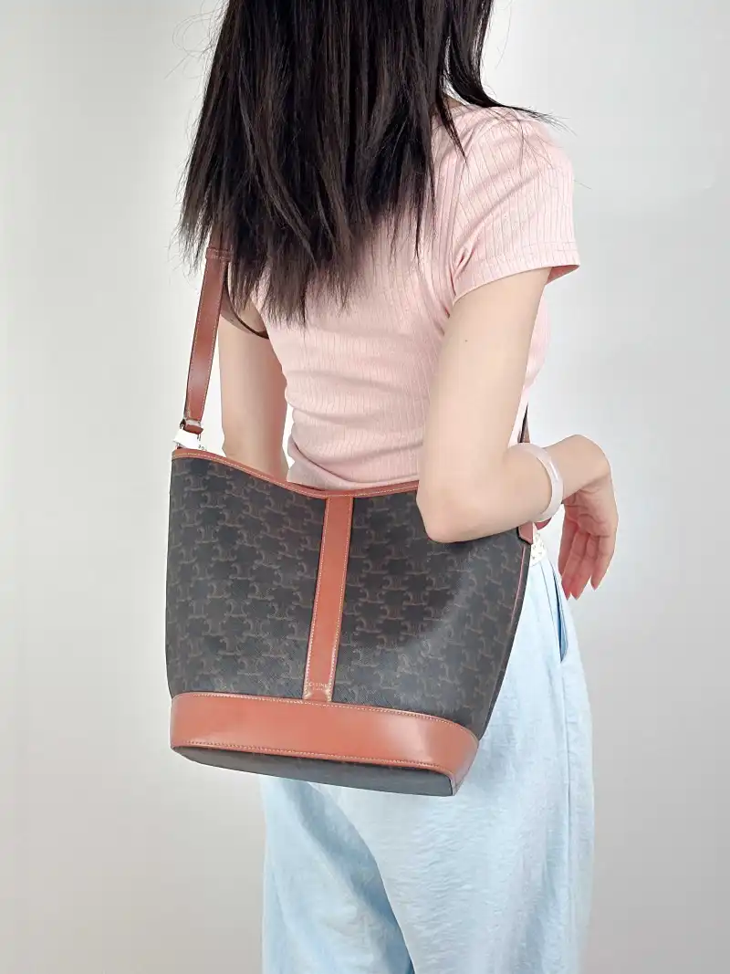 CELINE Crossbody Bag Triomphe Bucket Bag Monogram PVC Medium24 × 18 × 27 cm — on-model view 1 of 2