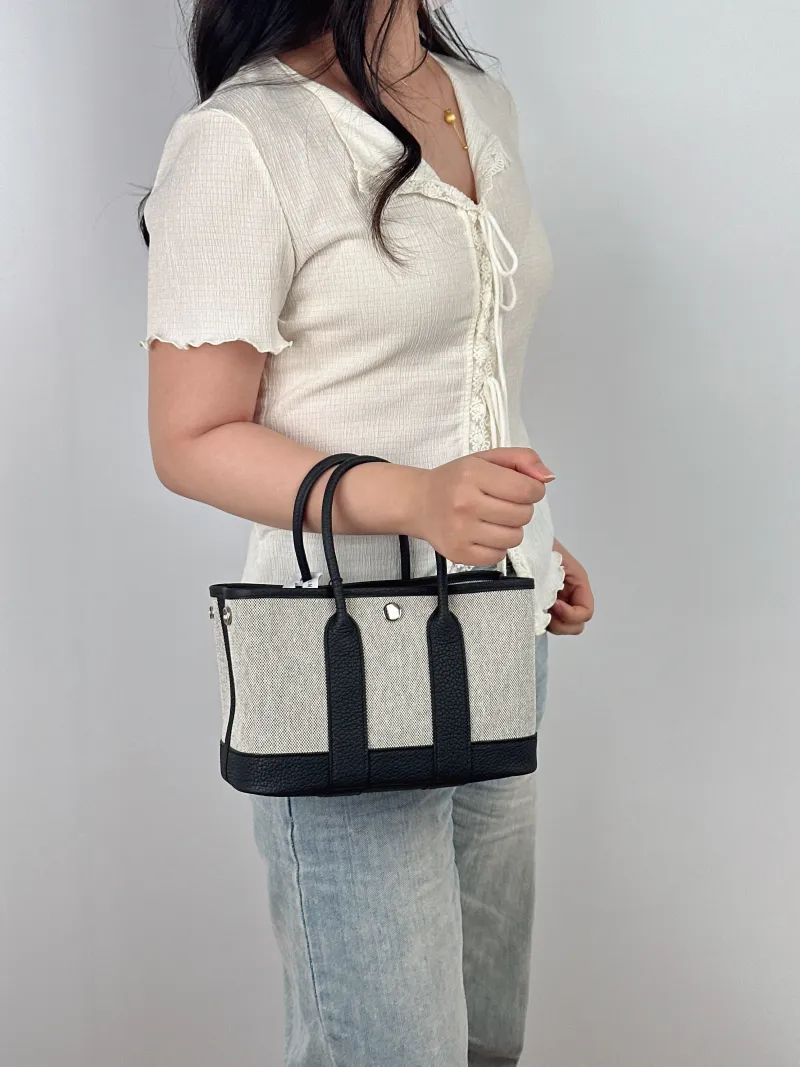 Hermès Top Handle Bag Neo Garden 23 Mini Black · Beige Canvas · Negonda Calfskin Mini 23 × 10 × 16 cm G — on-model view 1 of 2