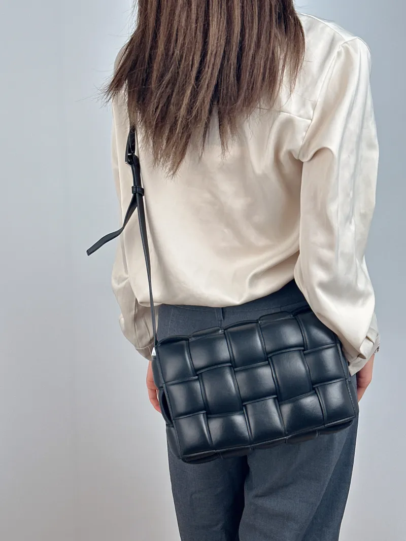 Bottega Veneta Crossbody Bag Padded Cassette Woven Black Lambskin Medium 26 × 8 × 18 cm — on-model view 2 of 2