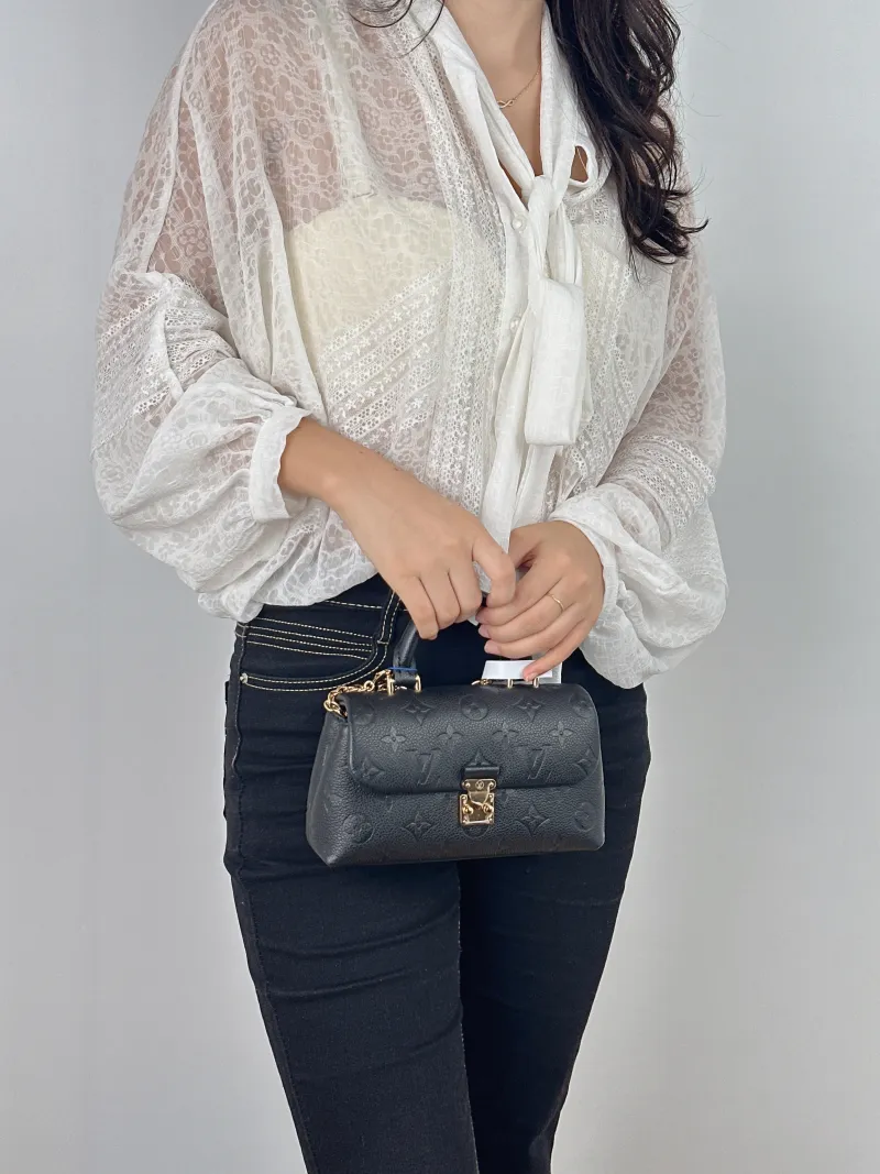 Louis Vuitton Crossbody Bag MADELEINE Black Monogram Empreinte Embossed Calfskin nano 21 × 6 × 12.5 cm — on-model view 1 of 2