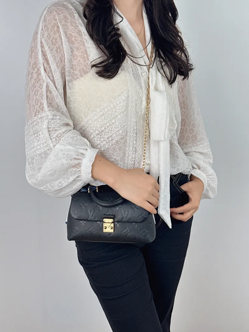 Louis Vuitton Crossbody Bag MADELEINE Black Monogram Empreinte Embossed Calfskin nano 21 × 6 × 12.5 cm — on-model view 2 of 2