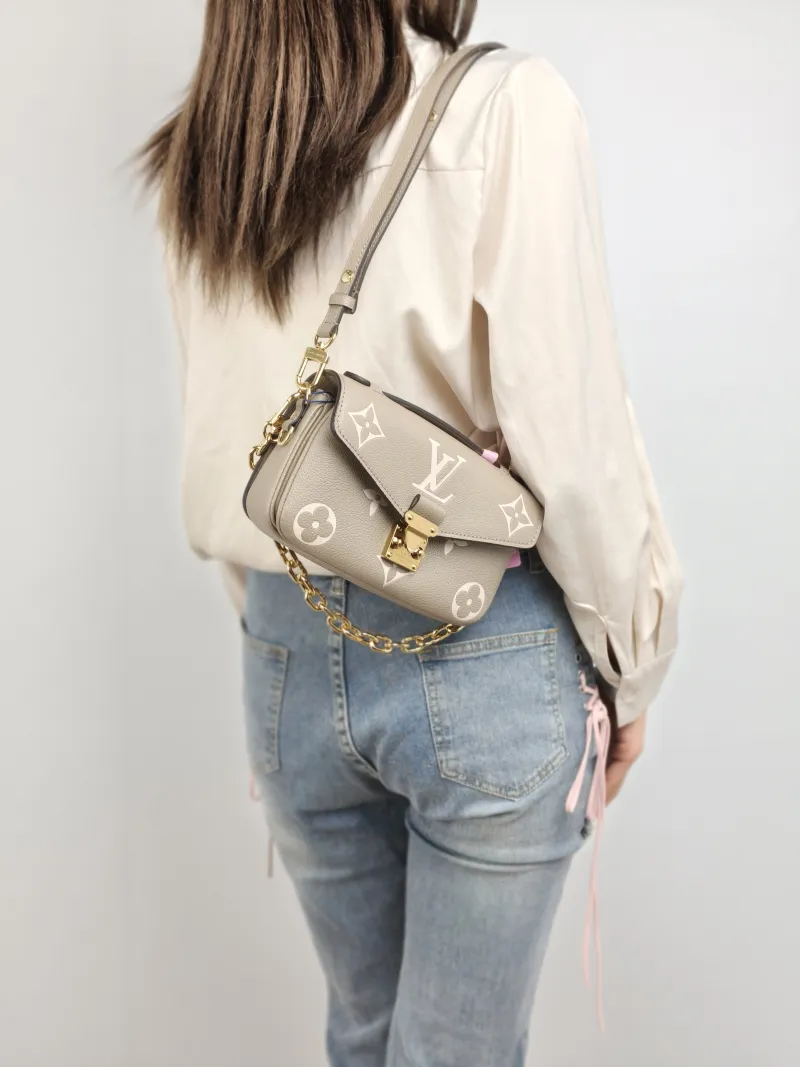 Louis Vuitton Crossbody Bag Pochette Métis East West Monogram Empreinte Embossed Calfskin Small 21.5 × 6 × 13.5 cm — on-model view 1 of 3
