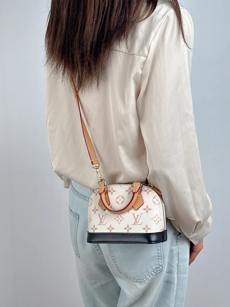 Louis Vuitton Crossbody Bag Alma Nano · Black PVC nano 18 × 8 × 12 cm — on-model view 2 of 2