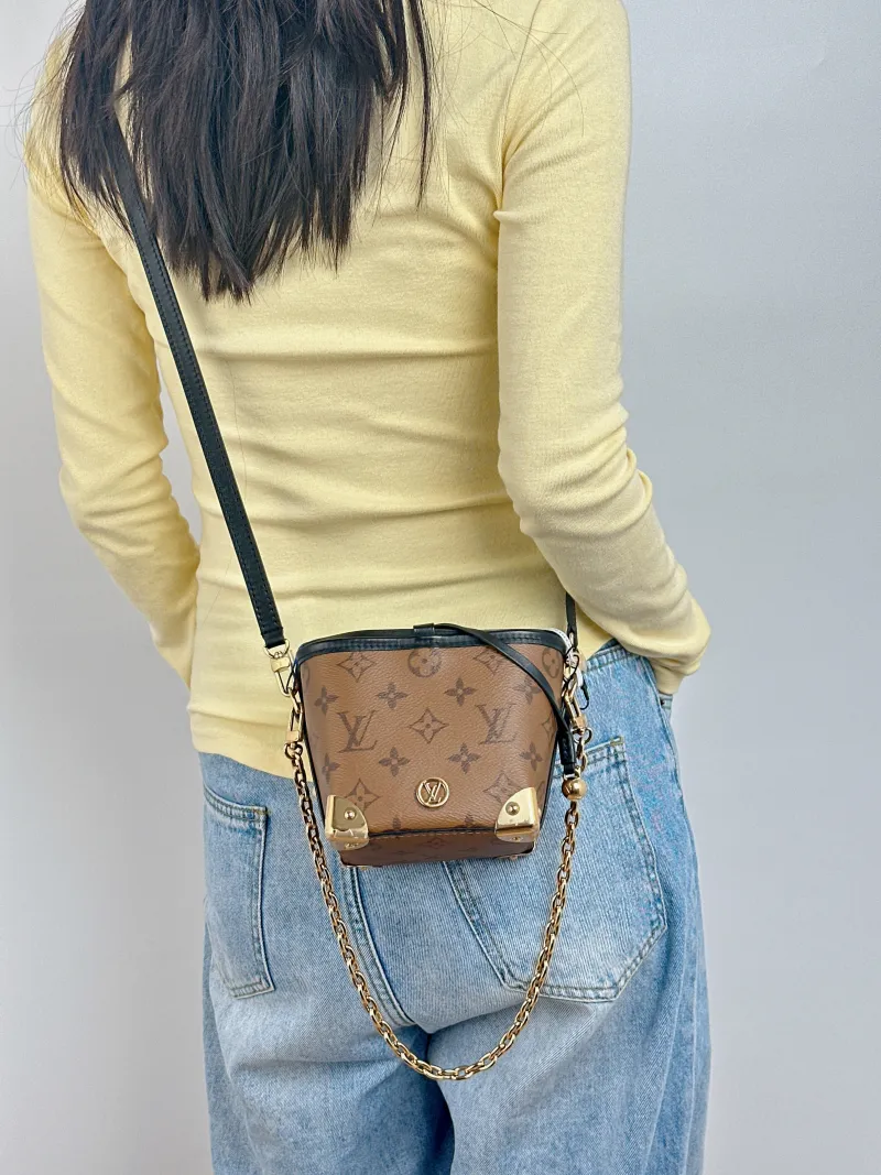Louis Vuitton Crossbody Bag NOÉ PURSE LV CHARMS Monogram PVC Mini 11.5 × 11.5 × 11.5 cm — on-model view 1 of 3