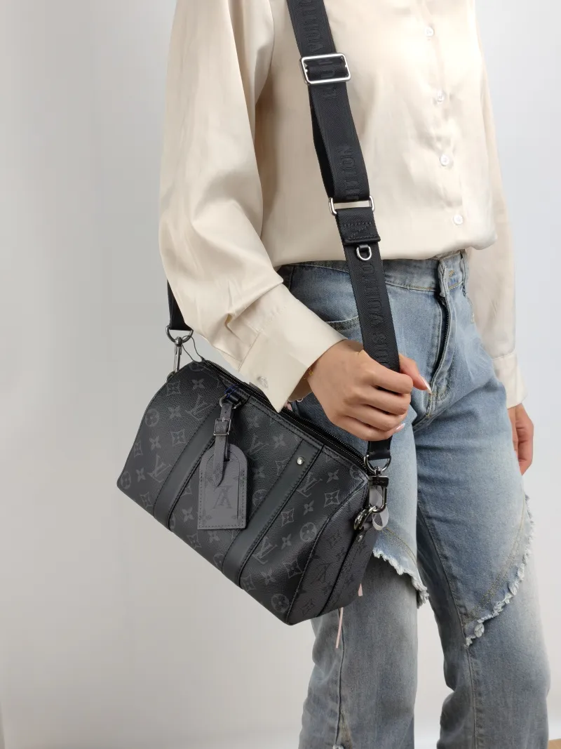 Louis Vuitton Crossbody Bag City Keepall Black PVC Medium 27 × 13 × 17 cm — on-model view 1 of 2