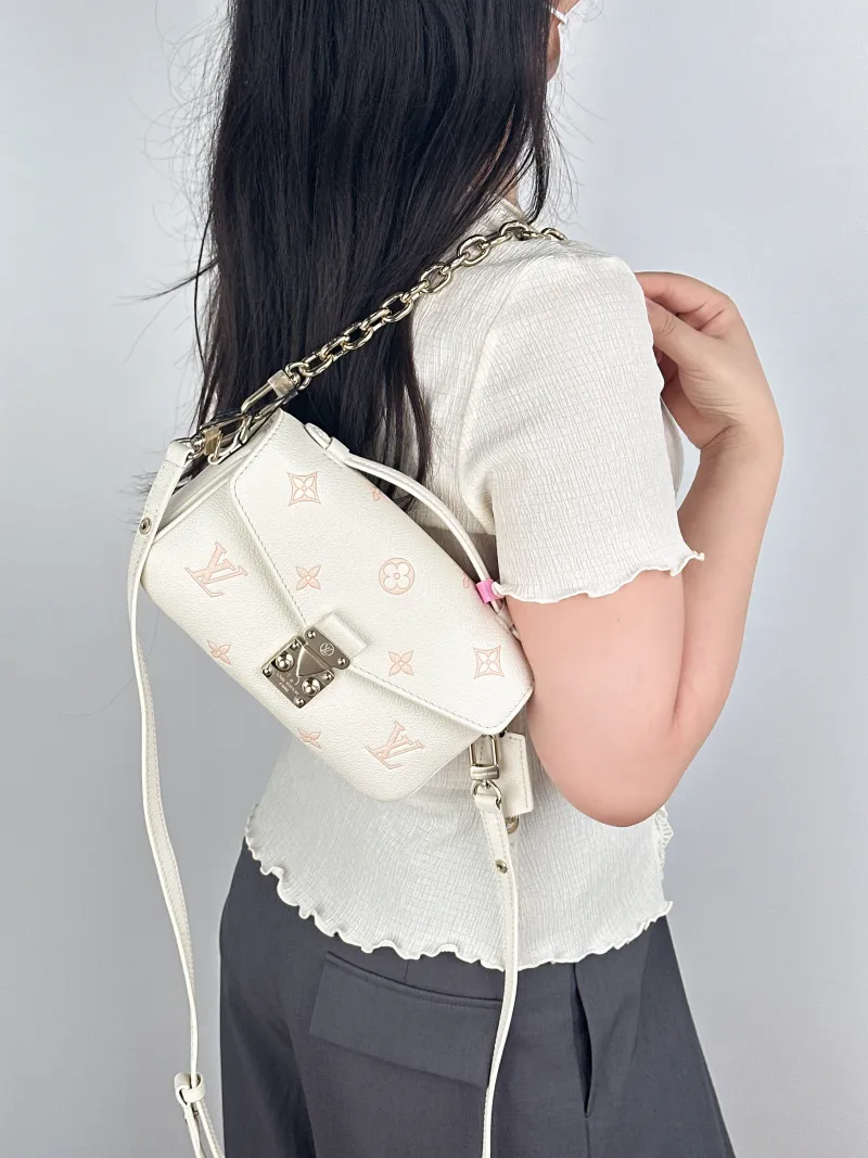 Louis Vuitton Crossbody Bag Pochette Métis East West White · Pink Monogram Empreinte Embossed Calfskin Small21.5 × 6 × 13.5 cm — on-model view 2 of 3