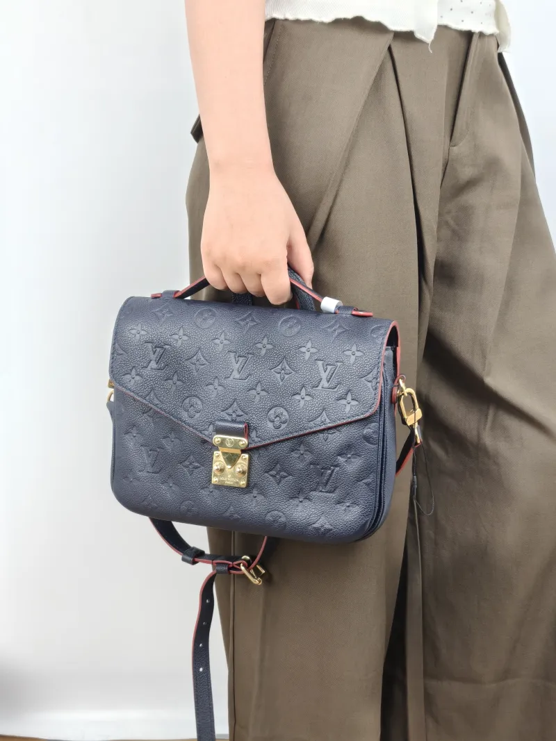Louis Vuitton Crossbody Bag Pochette Métis · Monogram Empreinte Embossed Calfskin Medium 25 × 7 × 19 cm — on-model view 1 of 3