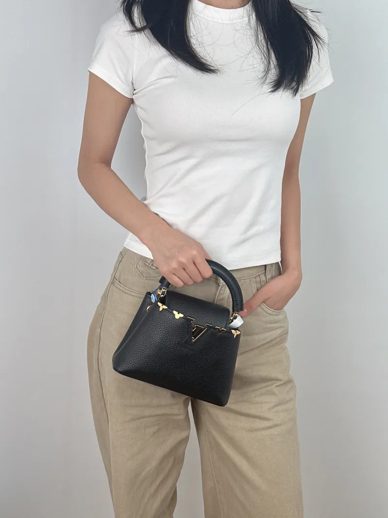 Louis Vuitton Crossbody Bag Capucines Black · Calfskin Mini 21 × 8 × 14 cm — on-model view 2 of 3