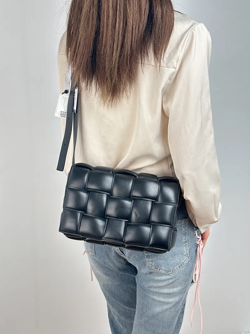 Bottega Veneta Crossbody Bag Padded Cassette Woven Black Lambskin Medium 26 × 8 × 18 cm — on-model view 1 of 2