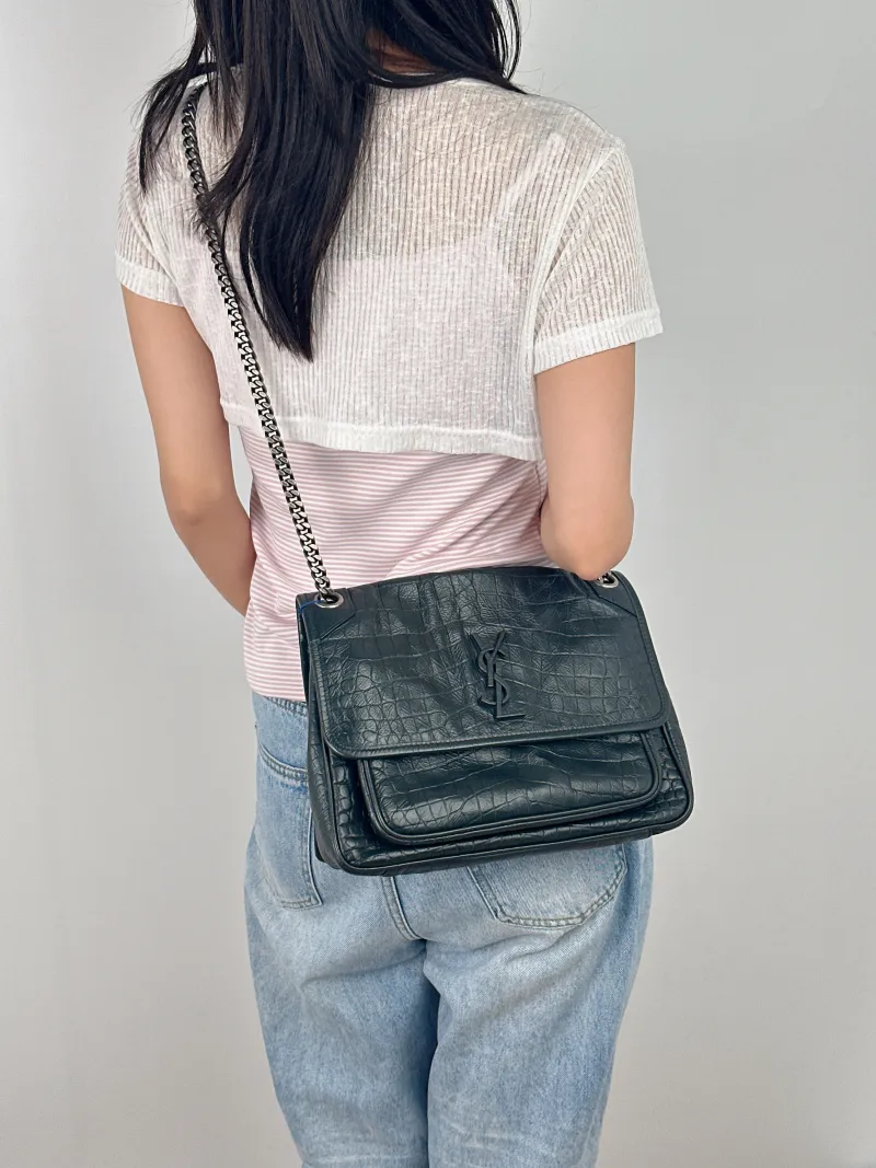 SAINT LAURENT Crossbody Bag Niki D Green Calfskin Medium 28 × 8.5 × 20 cm — on-model view 1 of 2