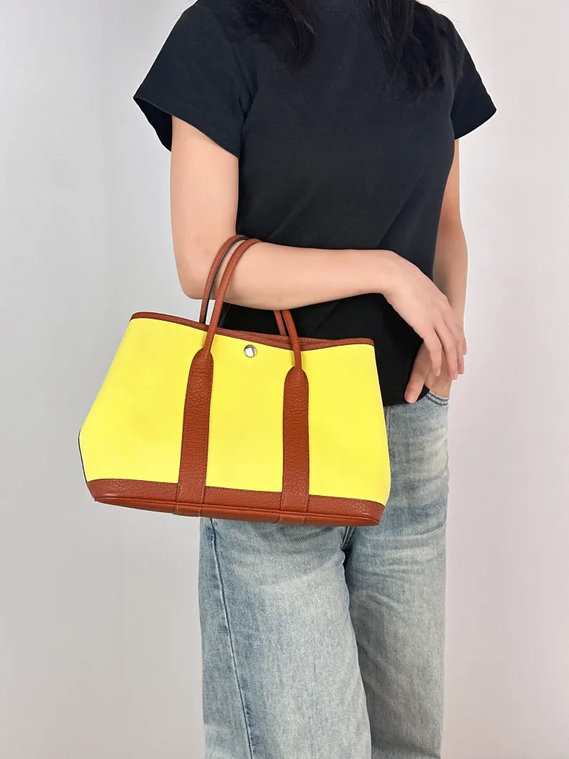 Hermès Top Handle Bag Garden Party 30 30 Canvas · Negonda Calfskin Medium30 × 13 × 21 cm — on-model view 1 of 2