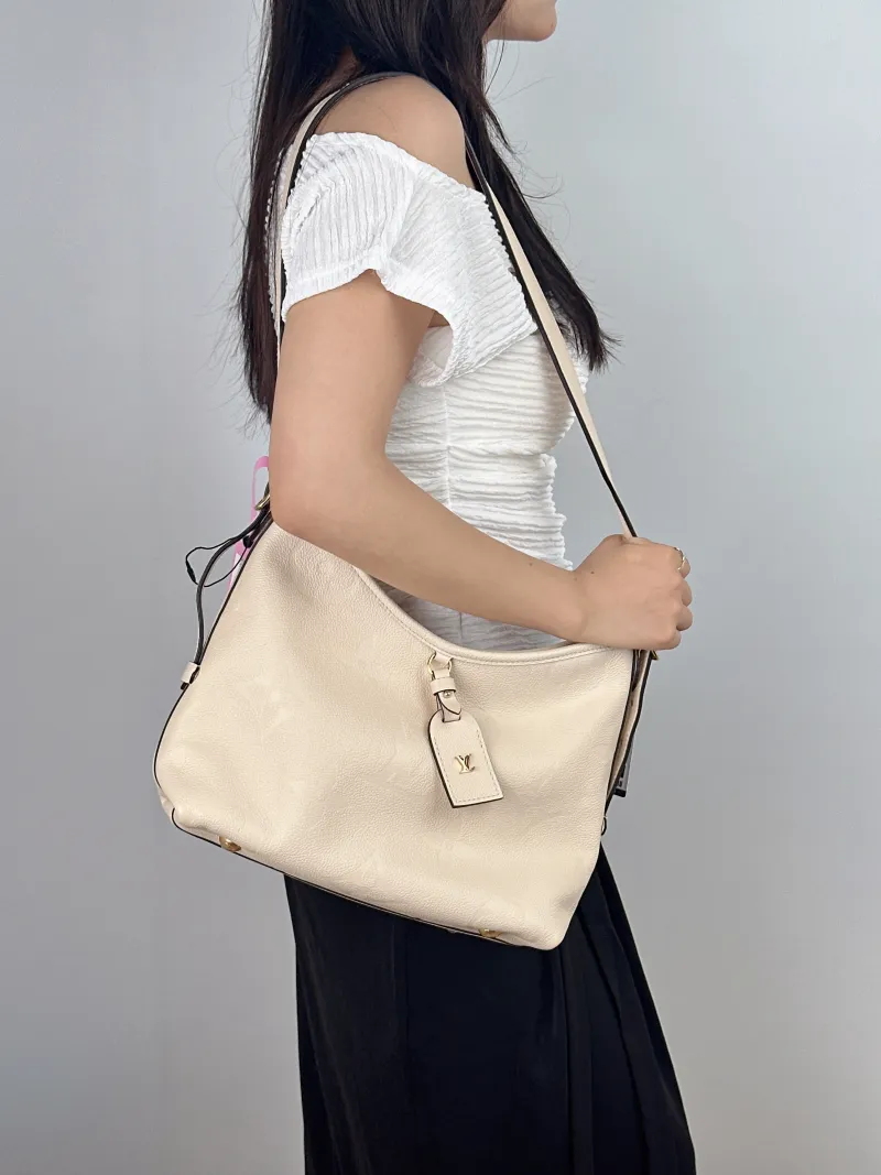 Louis Vuitton Crossbody Bag Carryall White Calfskin Small 29.5 × 12 × 24 cm — on-model view 1 of 2
