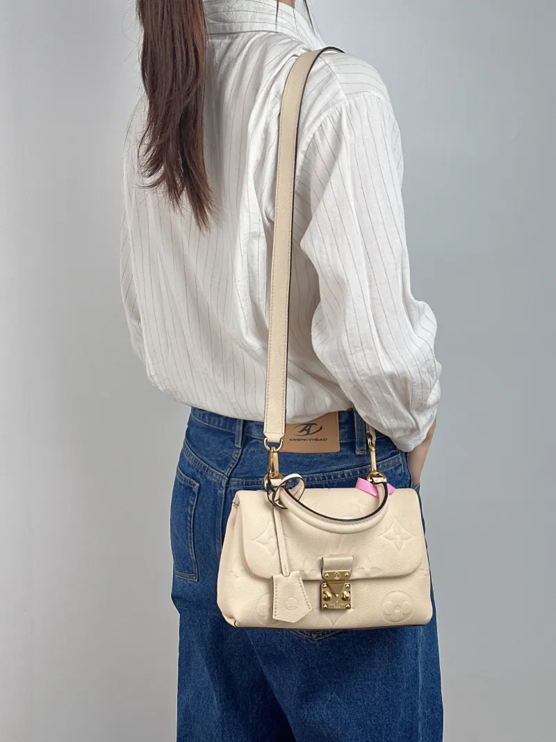 Louis Vuitton Crossbody Bag MADELEINE Beige Monogram Empreinte Embossed Calfskin BB 24 × 8.5 × 17 cm — on-model view 1 of 3