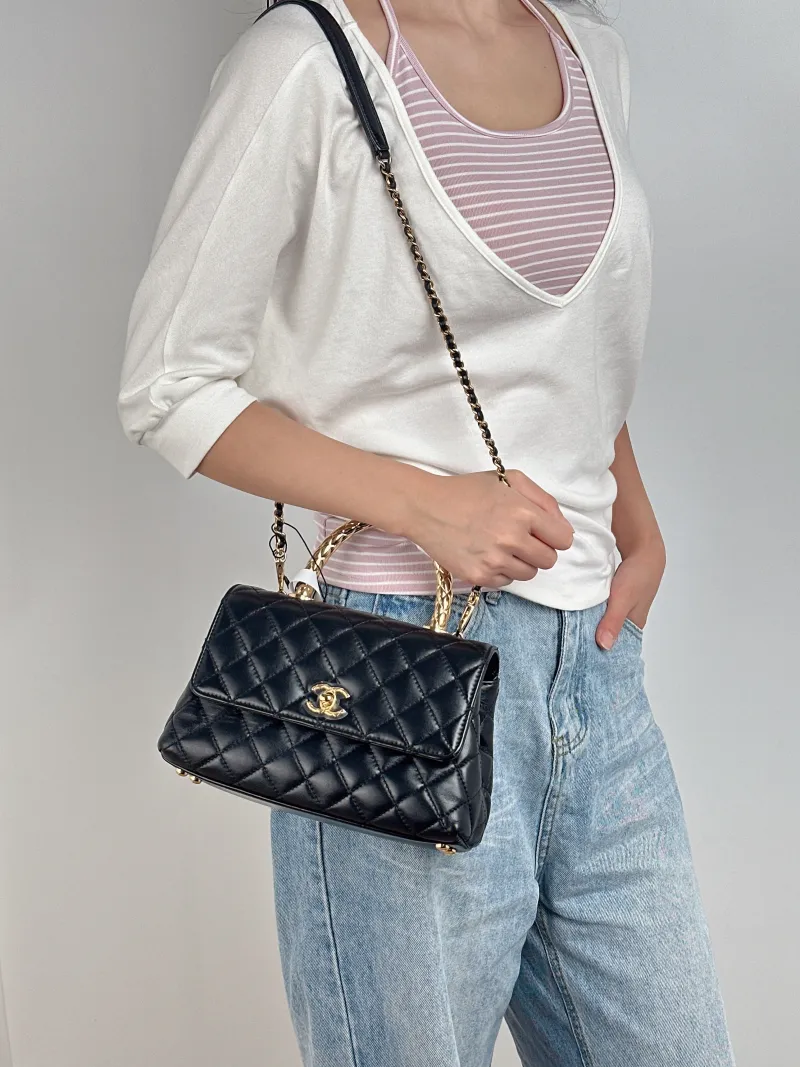 Chanel Crossbody Bag Coco Handle​Black Calfskin Small24 × 10 × 14 cm — on-model view 1 of 3