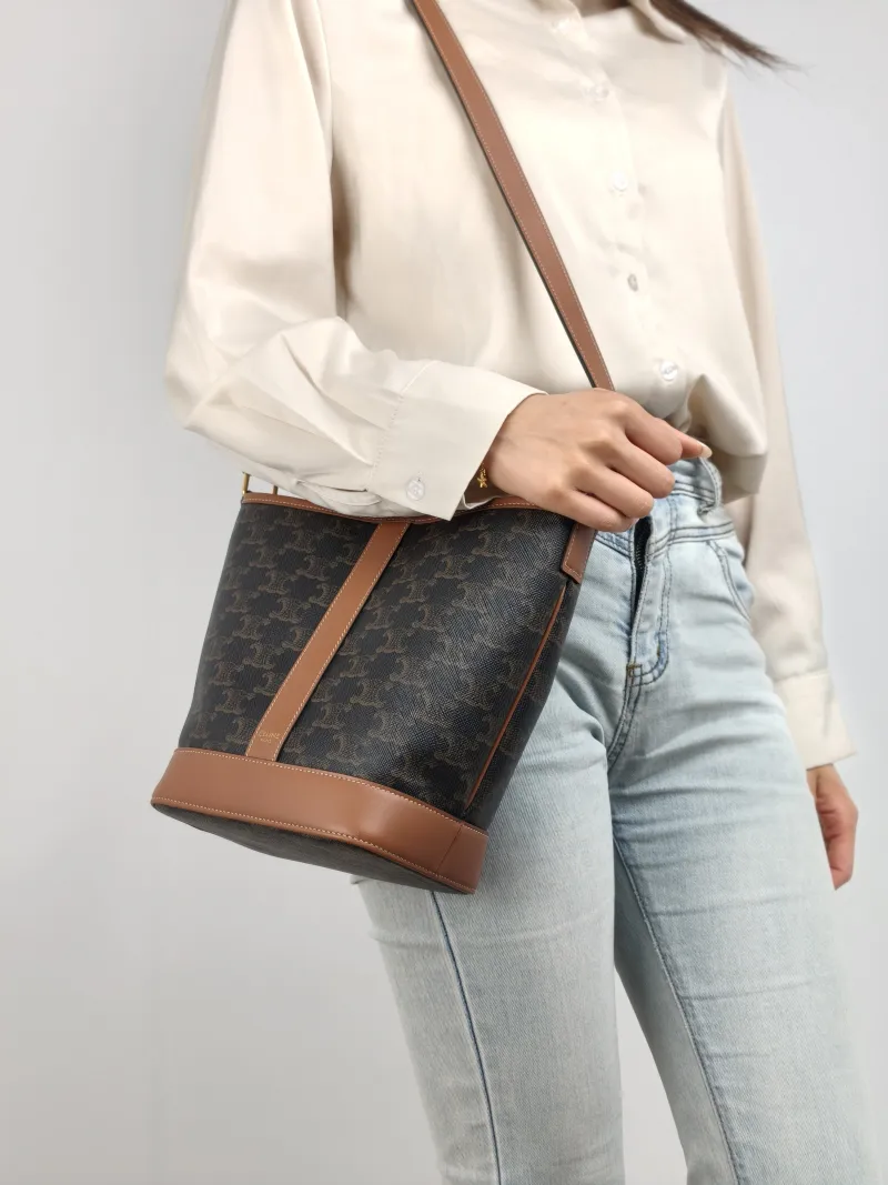 CELINE Crossbody Bag Triomphe Bucket Bag Monogram PVC Small 22 × 13 × 26 cm — on-model view 1 of 2