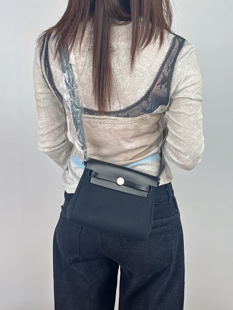 Hermès Crossbody Bag Herbag Zip 2089Black Calfskin，Canvasmini20.5 × 7 × 16.5 cm — on-model view 1 of 2