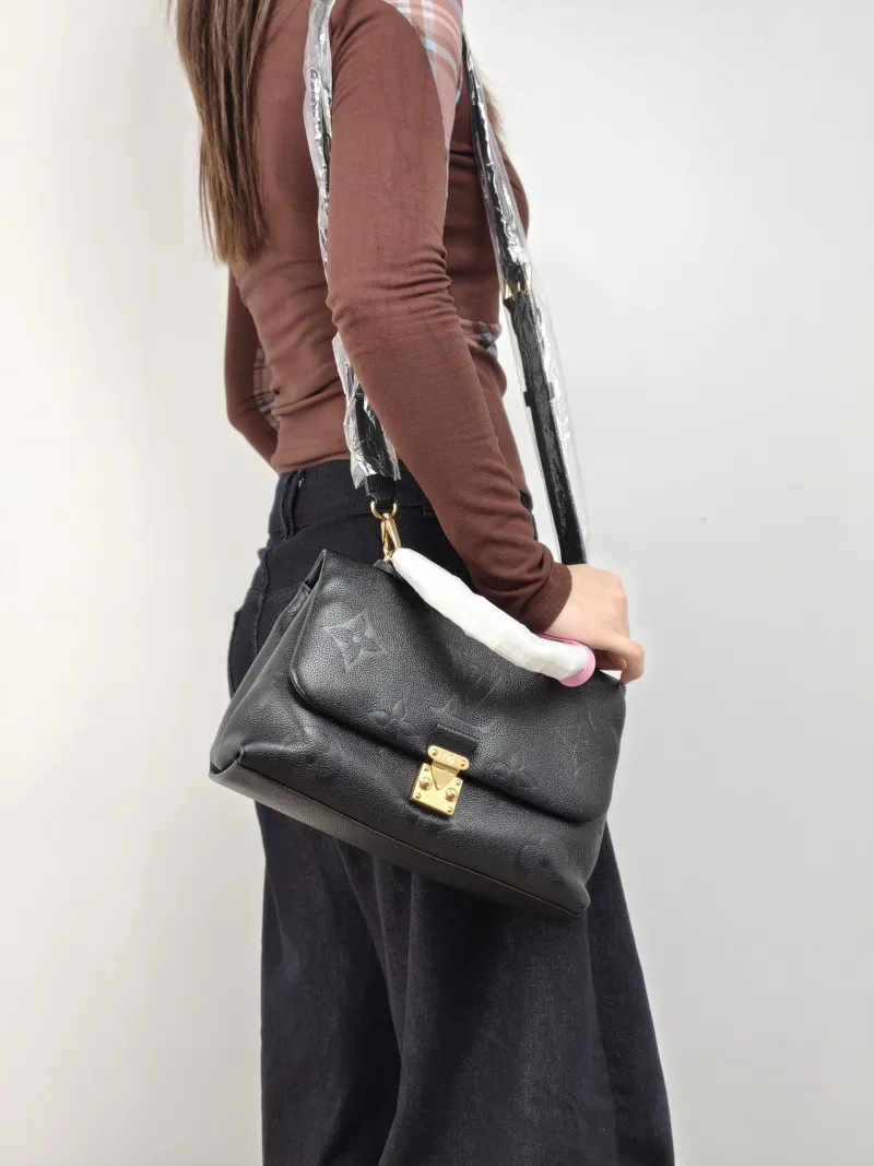 Louis Vuitton Crossbody Bag MADELEINE Black Monogram Empreinte Embossed Calfskin Medium 30 × 11 × 19.5 cm — on-model view 1 of 3
